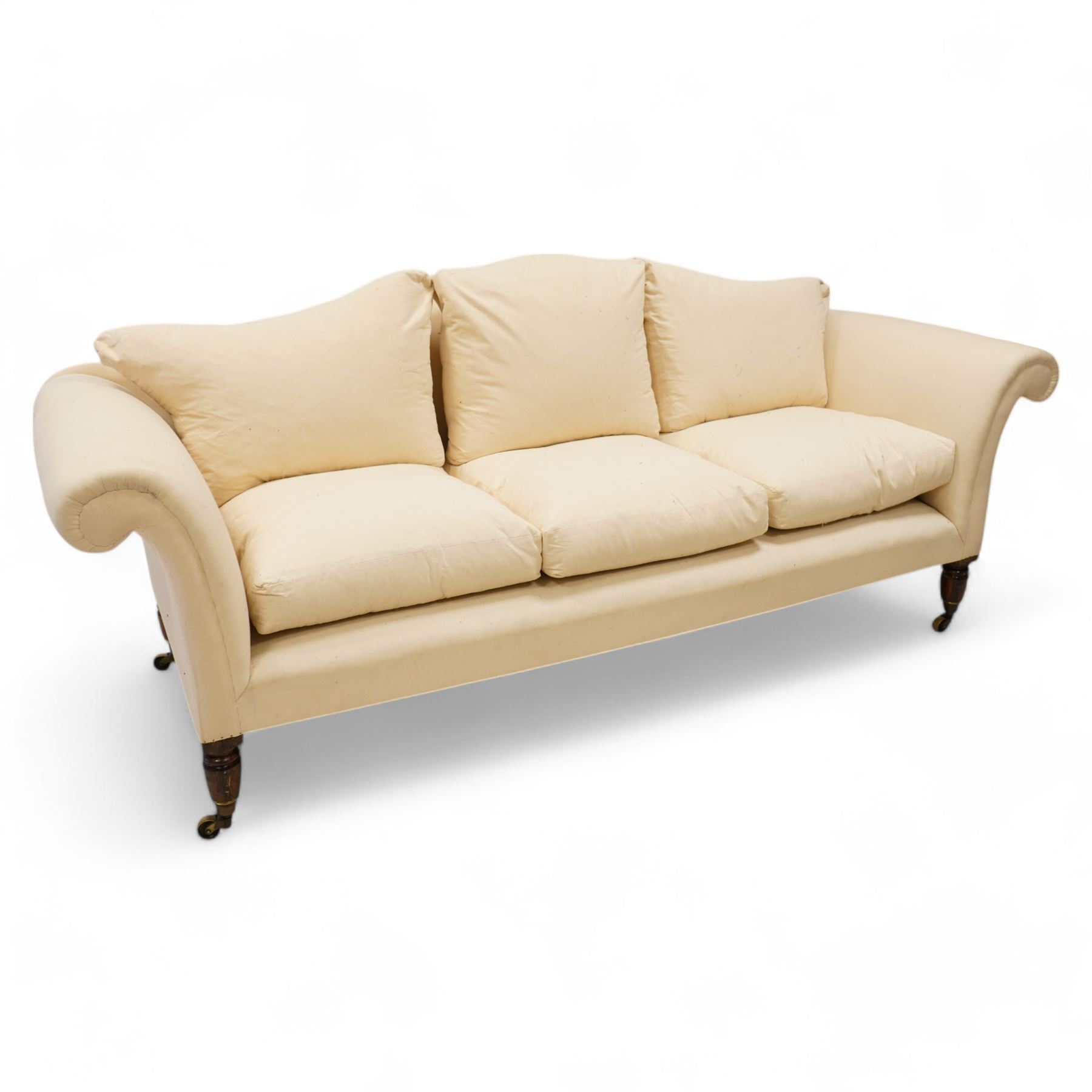 Grande three-seat camelback sofa, upholstered in calico base layer, on turned feet painted to resemble rosewood, fitted with brass cups and castors