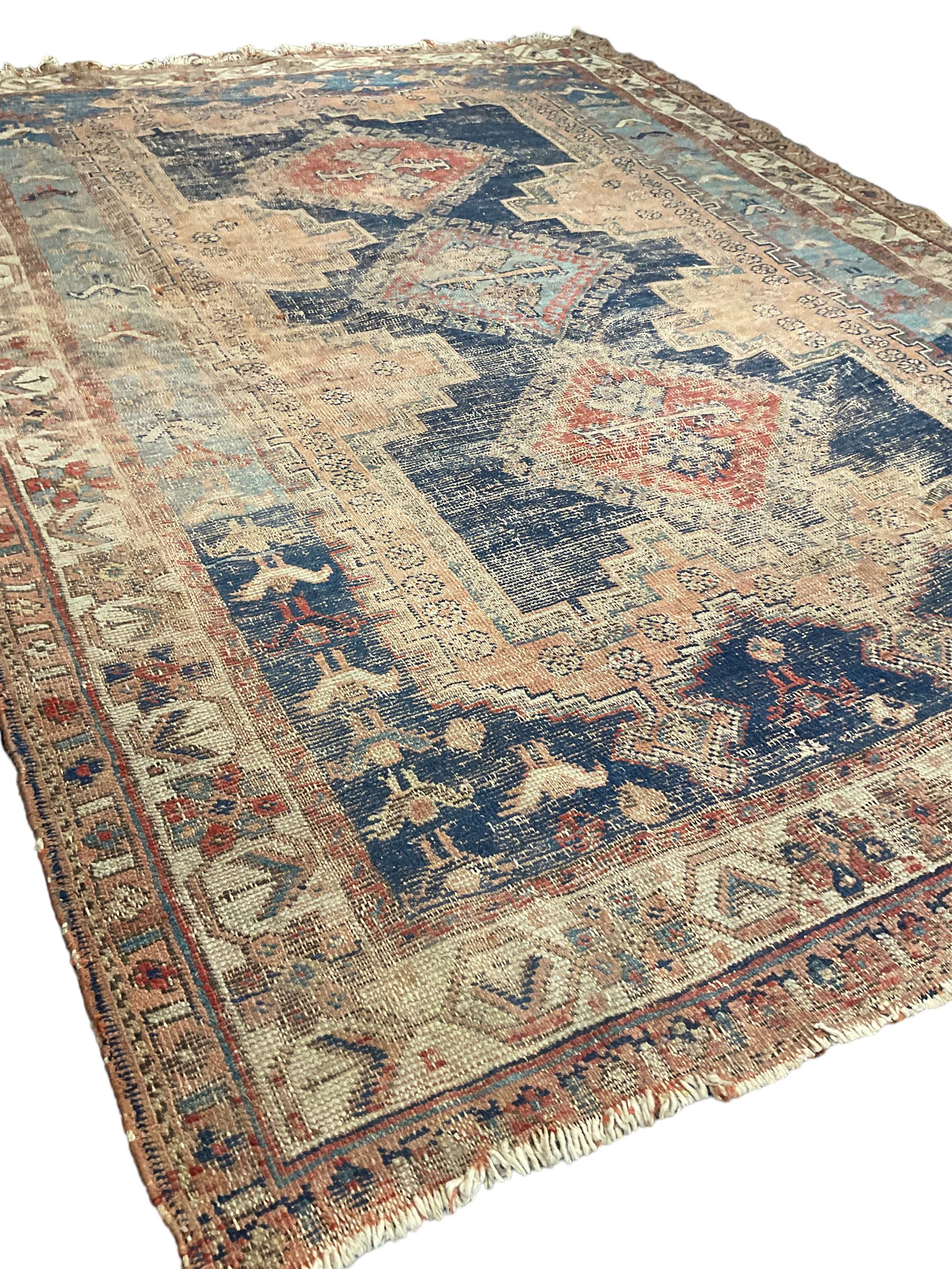 Antique Caucasian rug, indigo ground field decorated with three lozenge medallions within borders of stylised bird and flower head motifs