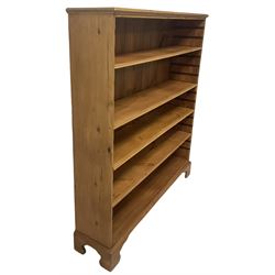 Georgian and later pine open bookcase, fitted with three adjustable shelves, on bracket feet