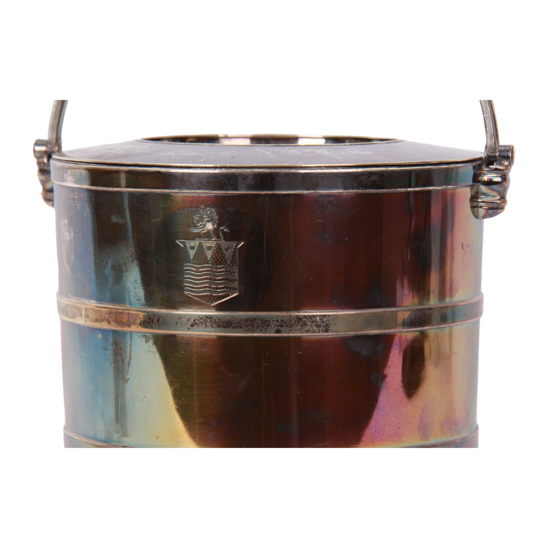 20th century silver plated wine cooler, of cylindrical form with swing handle, two applied bands to body, and engraved crest, the cover lifting to reveal a further removable pierced section, not including handle H20.5cm D20cm