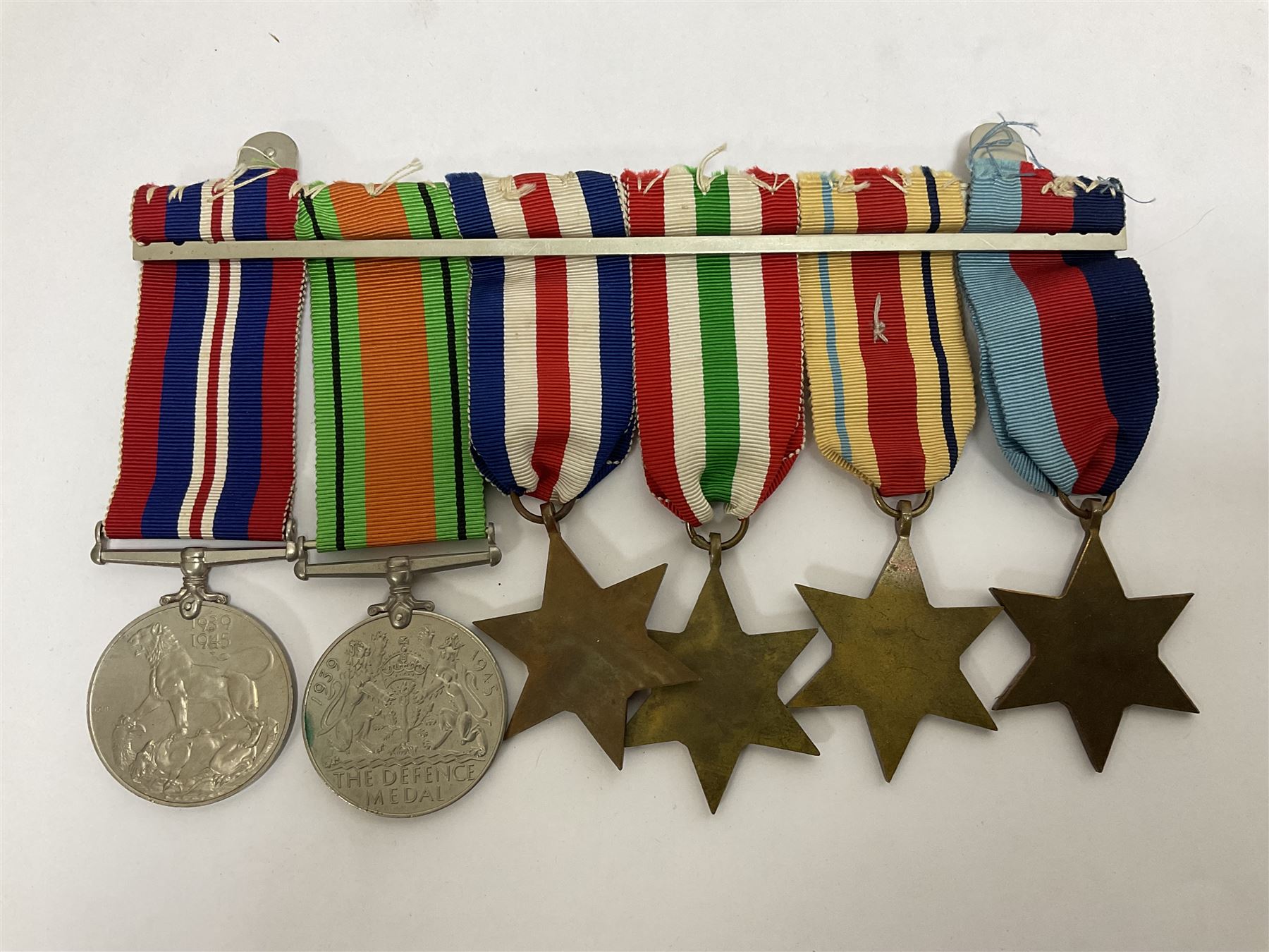 WWII group of six medals comprising 1939-45 Star, The Africa Star, The Italy Star, France and Germany Star, Defence Medal and War Medal 1939-45, awarded to 7899181 RAC C.W Hughes, together with two chevrons and ephemera relating to Charles William 'Bill' Hughes including Soldier's Release Book, photographs, certificates of transfers etc 