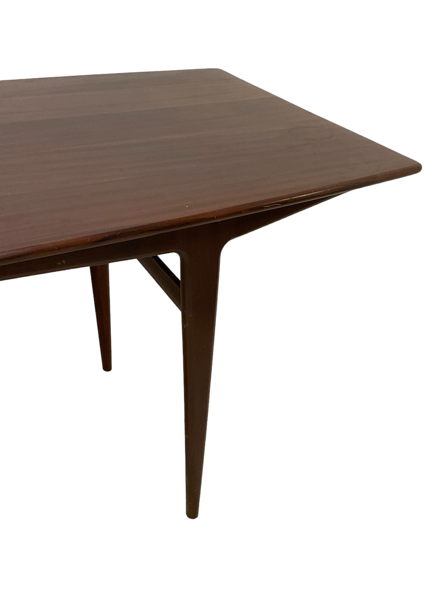 John Herbert for A Younger - mid-20th century teak dining table, curved rectangular top on tapering supports 