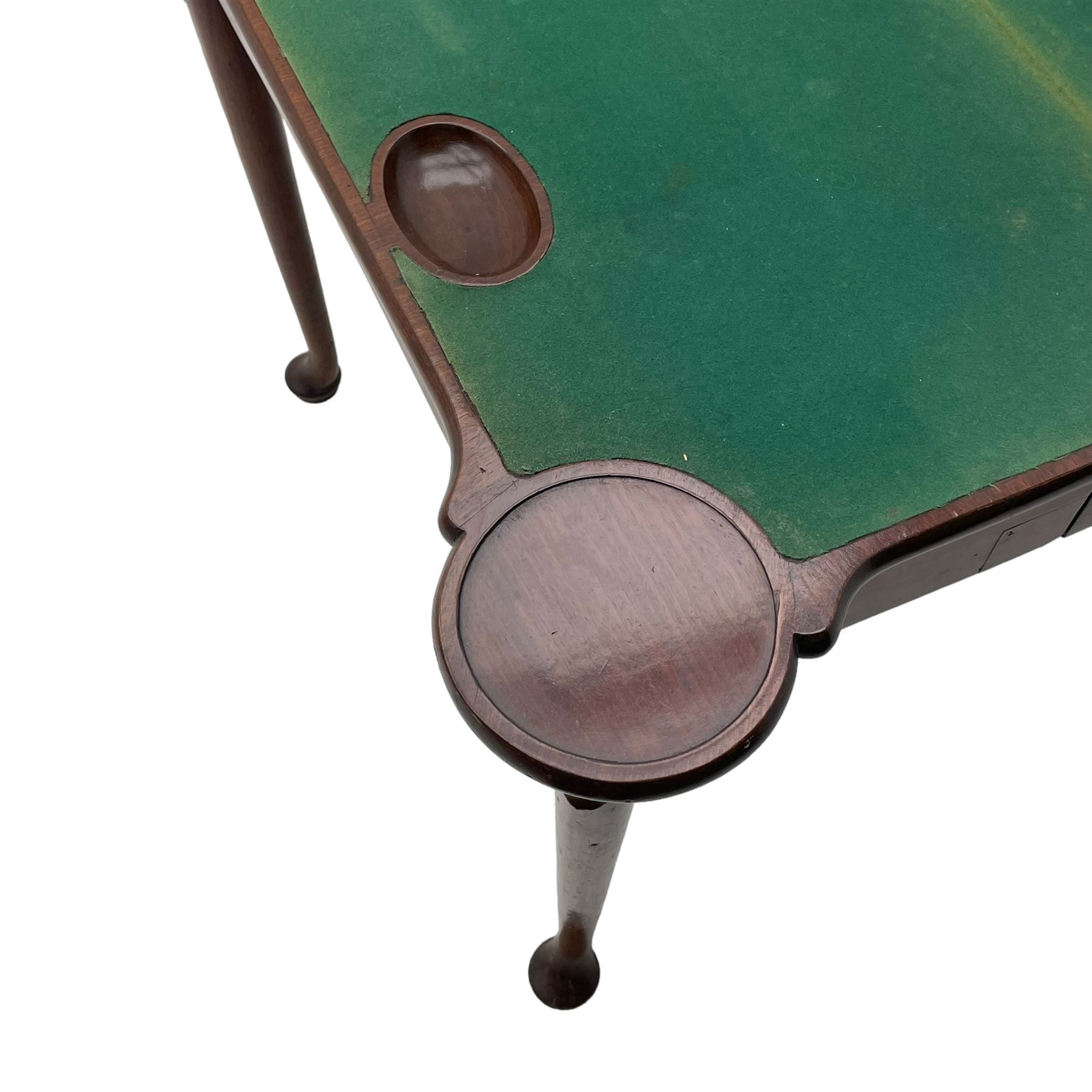 George III mahogany games table, the rectangular fold-over top with extending stepped rounded corners, opening to reveal baize lined interior with sunken counter wells, concertina action base, on lappet cabriole supports