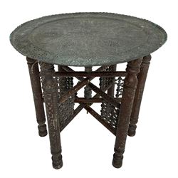 Anglo-Indian Benares table, circular pierced copper top decorated with trailing foliage, on folding hardwood stand carved with scrolls and incised decoration