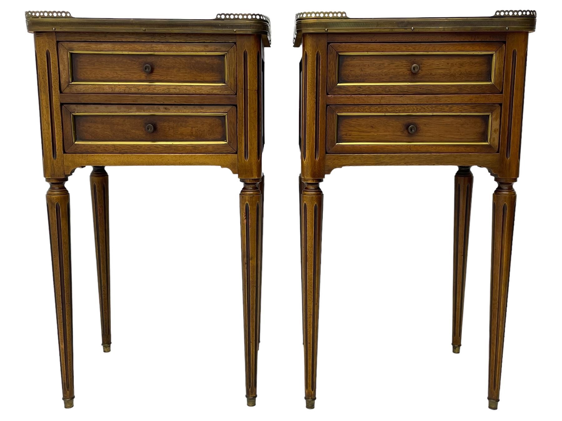 Pair of French design mahogany and marble bedside lamp tables, rectangular white marble top with raised brass gallery, fitted with two drawers, sunken facias with applied brass edging, panelled sides, on turned and fluted tapering supports 