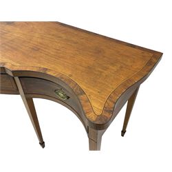 Large George III mahogany serpentine serving table, shaped top with crossing banding and stringing, the frieze fitted with three cock-beaded drawers, oval pressed brass handle plates decorated with urns, on square tapering supports with spade feet 