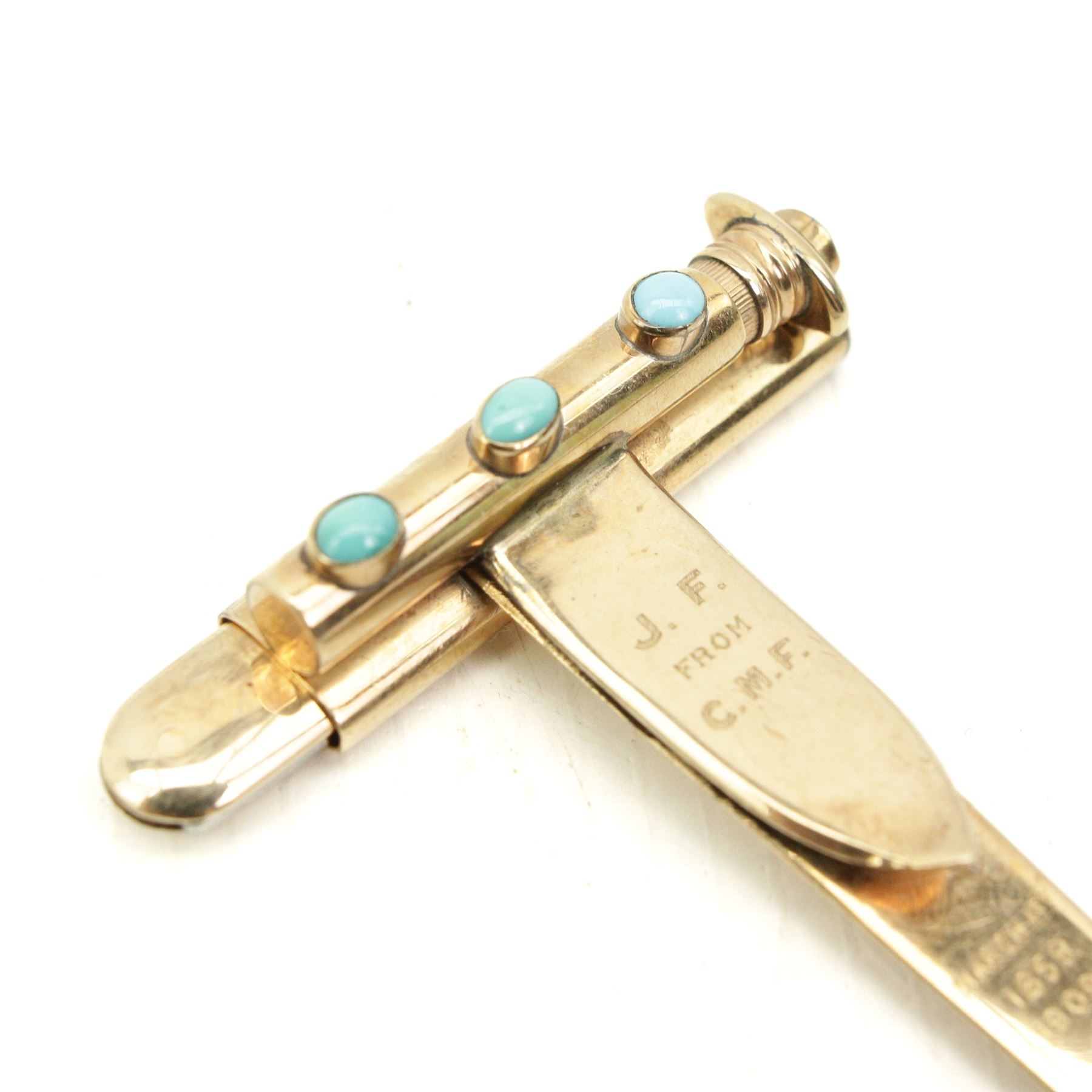 Edwardian 9ct gold money clip set with three turquoise stones, with detachable pencil 9ct gold turquoise set propelling pencil and 9ct gold knife with stainless steel blade, the back engraved 'In remembrance of 50 happy years' dated and initialed to front, by John Collard Vickery, London 1908