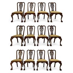 Set of twelve Chippendale design mahogany dining chairs, shaped cresting rail carved with foliage and C-scrolls, pierced interlaced splat with curled leaf decoration, upholstered drop-in seat, moulded seat rails, on scrolled acanthus carved cabriole supports with ball and claw feet 