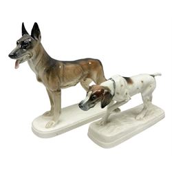 Two Hertwig and Co Katzhutte figures of dogs, comprising a German Shepherd and a pointer dog, both with printed marks beneath, largest H21.5cm W25cm