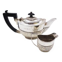 Edwardian silver bachelor's two piece tea set, comprising teapot and milk jug, each of oval part fluted form, the teapot black plastic handle and finial, hallmarked Synyer & Beddoes, Birmingham 1903, teapot H10.5cm