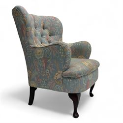 Mid-20th century wingback armchair, upholstered in soft blue floral patterned fabric with ...