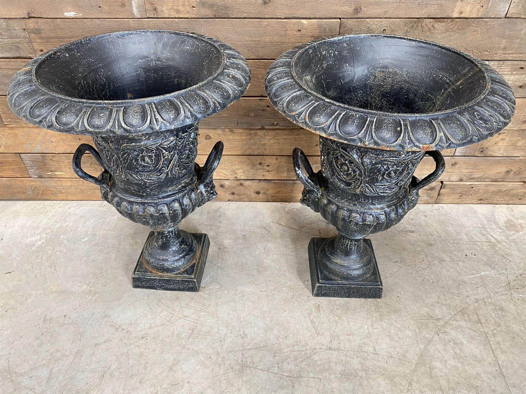 Pair of Victorian design ornate black painted cast iron garden urns, egg and dart rim, tapering column on pedestal base H63, D48