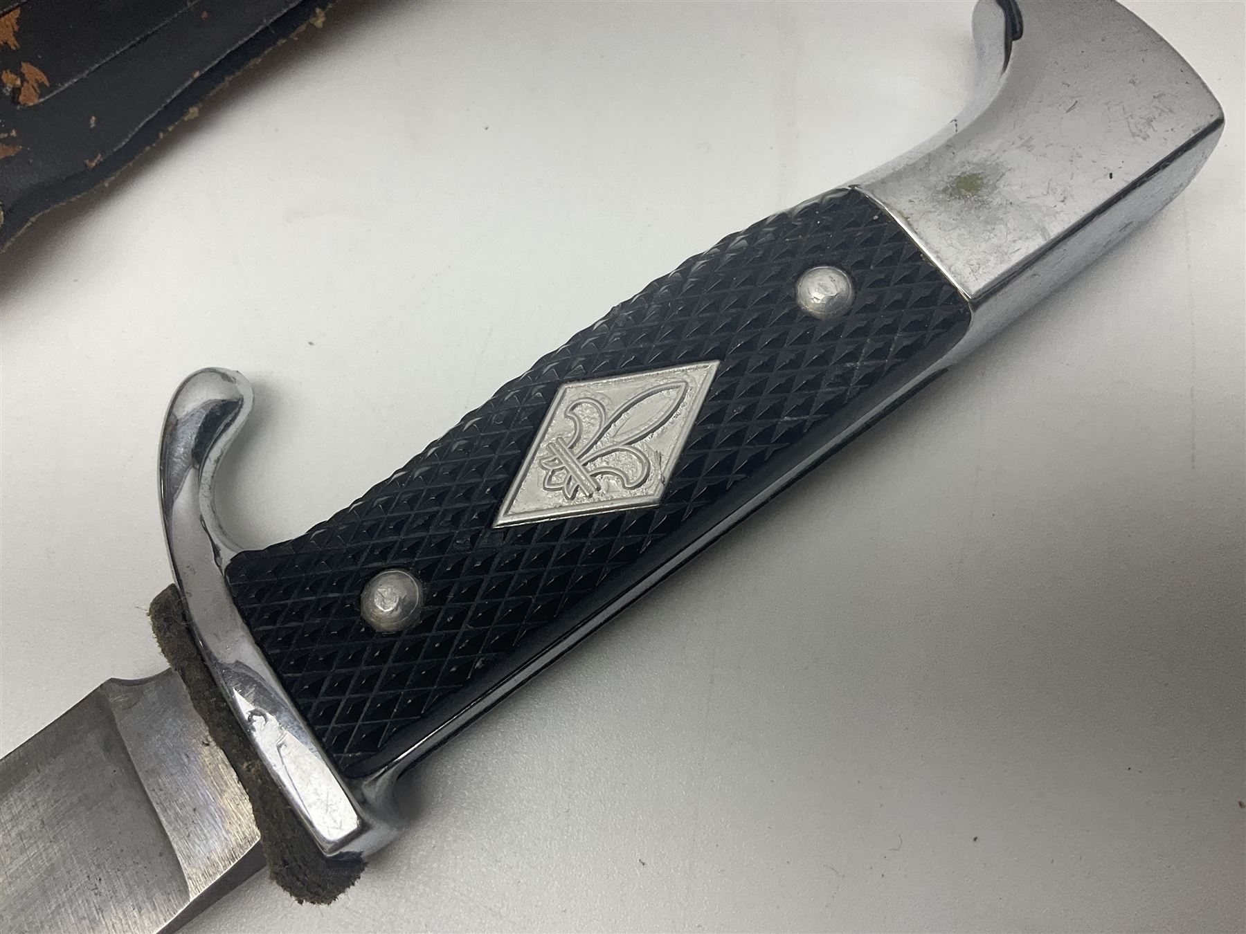 Post WWII scout knife, based on a Hitler Youth knife, in embossed leather sheath with scout emblem to handle, together with a similar example, also with scout emblem to handle, marked Whitby made in Germany, and a hunting knife with serrated edge, largest L39cm