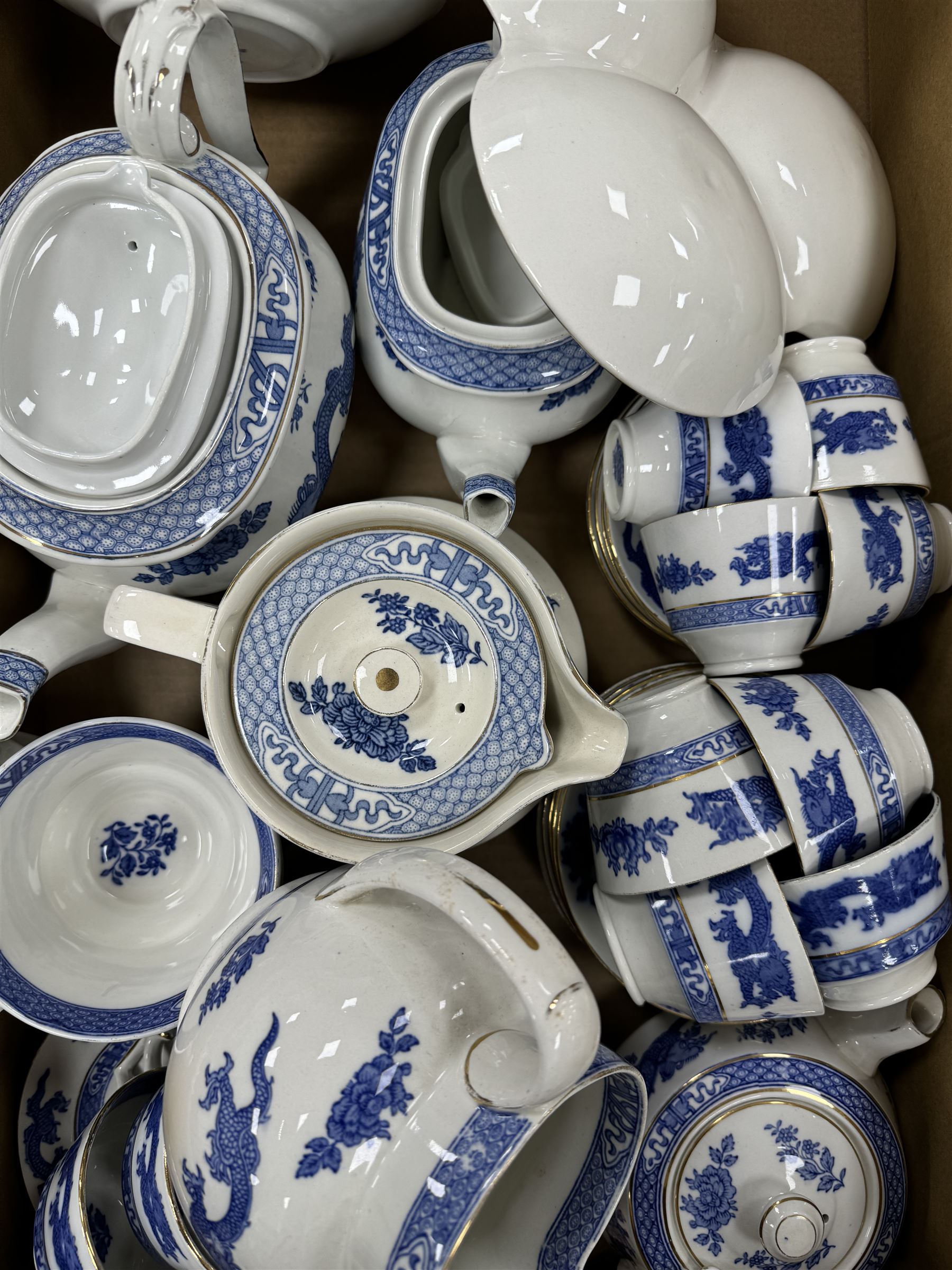 Extensive tea and dinner service of Booths and Cauldon dragon pattern, including, teapots, coffee pots, jugs, toast racks, bowls, dinner plates, platters, soup tureen etc 