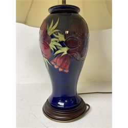 Moorcroft table lamp, of inverted baluster form, decorated in the Anemone pattern, on wooden plinth, with accompanying cream shade of lobed form, with piped detail, H36cm (excluding fitting)