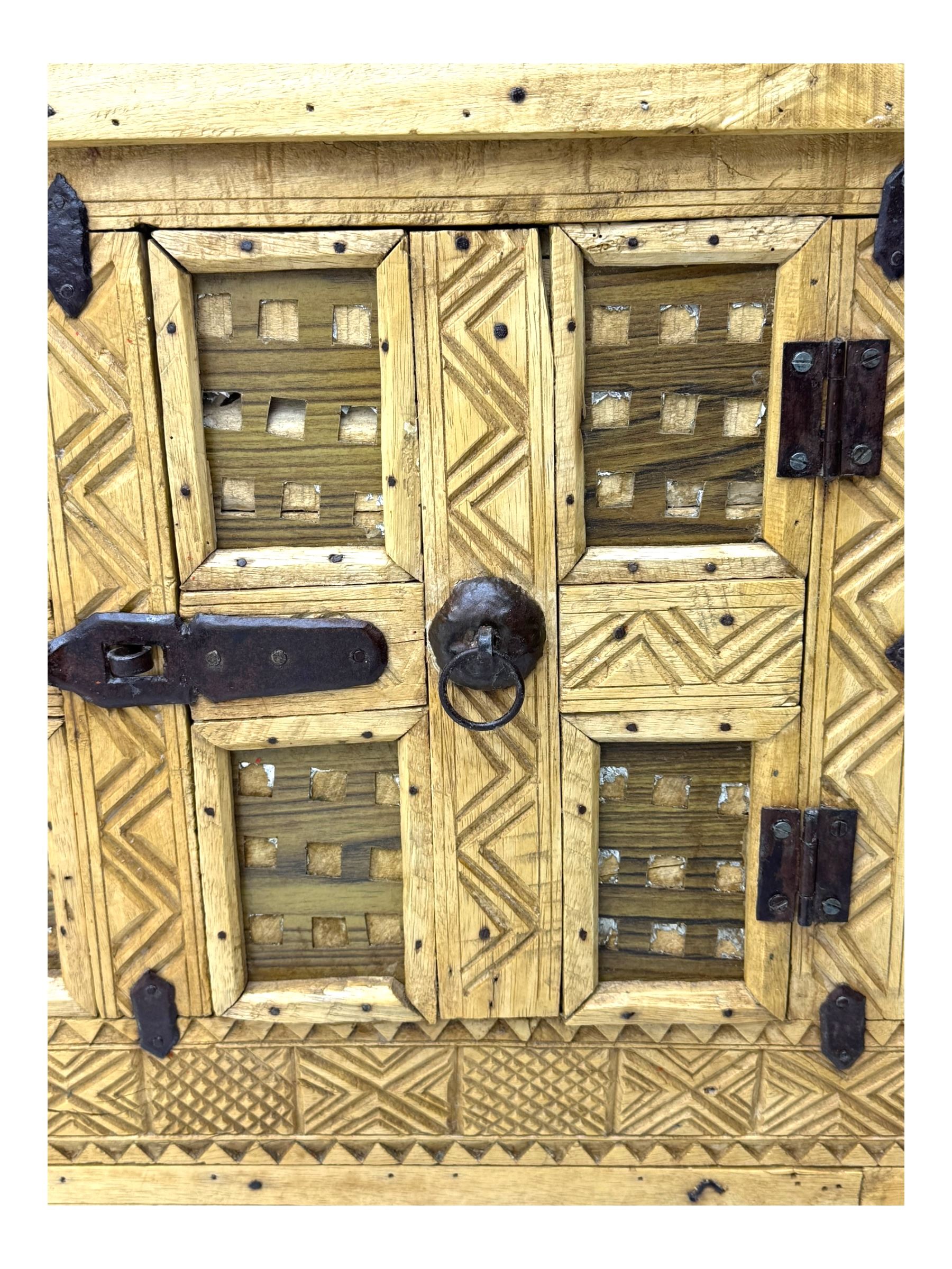 Late 19th century Indian teak damchiya chest, panelled front enclosed by single door, with metal bands and handles 