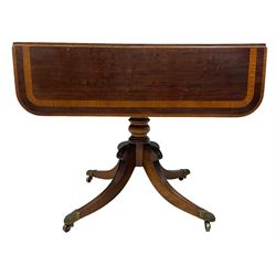 Early 19th century mahogany Pembroke table, rectangular drop-leaf top with rounded corners inlaid satinwood bands, single end drawer and opposing false drawer, turned pedestal on four acanthus carved and reed moulded splayed supports, cast brass cups and castors 