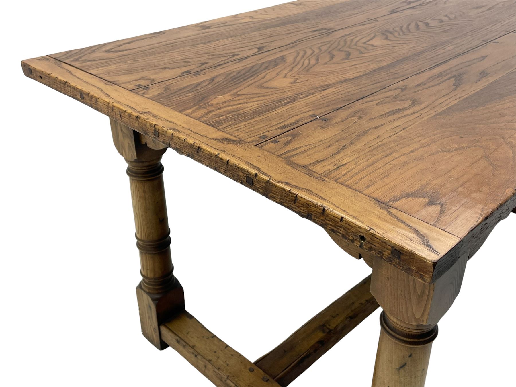 Oak refectory dining table, rectangular three plank top with cleated ends, two additional leaves, on turned supports united by H-stretchers 