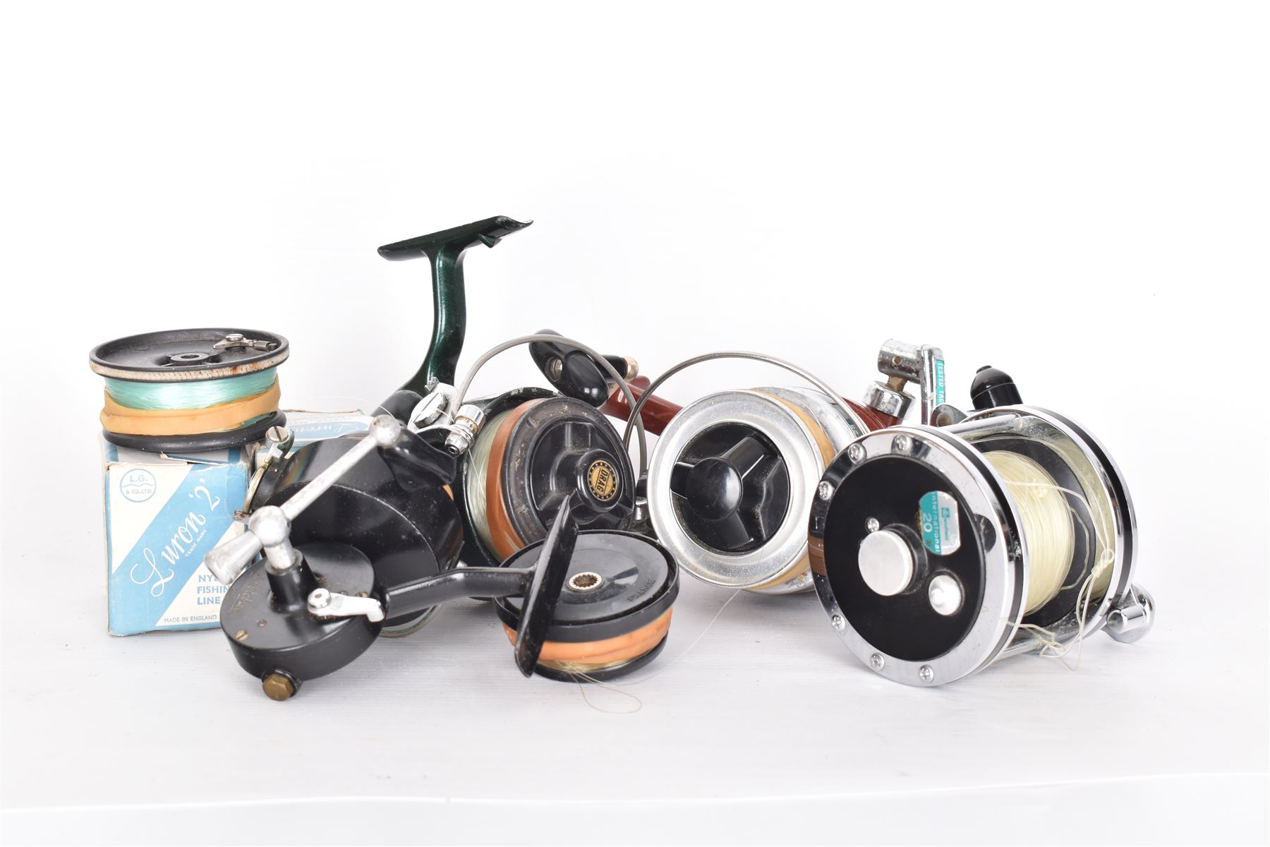 Four fishing reels, Winfield Beach fisher rod, Winfield International 20 , DAM International etc 