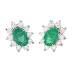 Pair of 18ct white gold oval cut emerald and round brilliant cut diamond cluster stud earr...