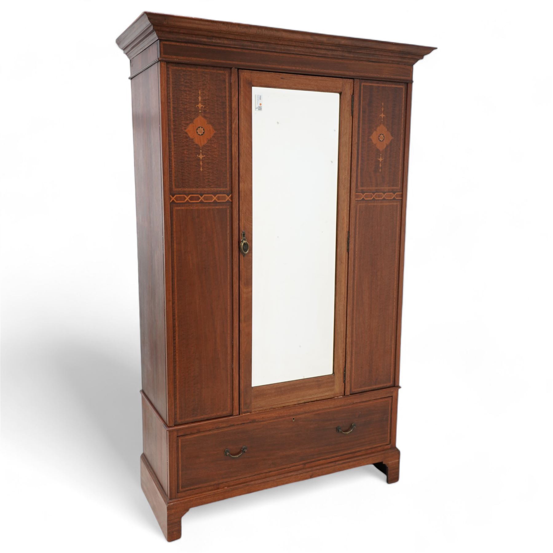 Edwardian inlaid mahogany wardrobe, projecting moulded cornice over panelled front and central bevelled mirror door, inlaid with satinwood shaped panels and trailing bell flowers, geometric inlaid bands and satinwood bands, single drawer to base, on bracket feet 