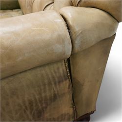 Drop-end two-seat sofa, upholstered in deeply buttoned pale green leather with stud work, on turned feet