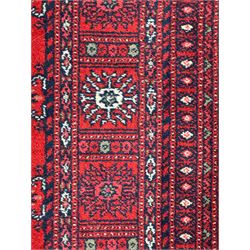 Persian Bokhara crimson ground runner rug, the field with a series of repeating ivory octagonal medallions, main border with repeating flower head pattern and diamonds within multiple guard stripes