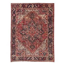 Persian Heriz crimson ground carpet, large central medallion comprising projecting palmett...