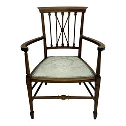 Edwardian inlaid mahogany armchair, curved top rail above spindle backrest with central X-shaped splat, the arms supported by turned uprights, over upholstered padded seat in pale blue damask fabric, on tapered supports with spade feet