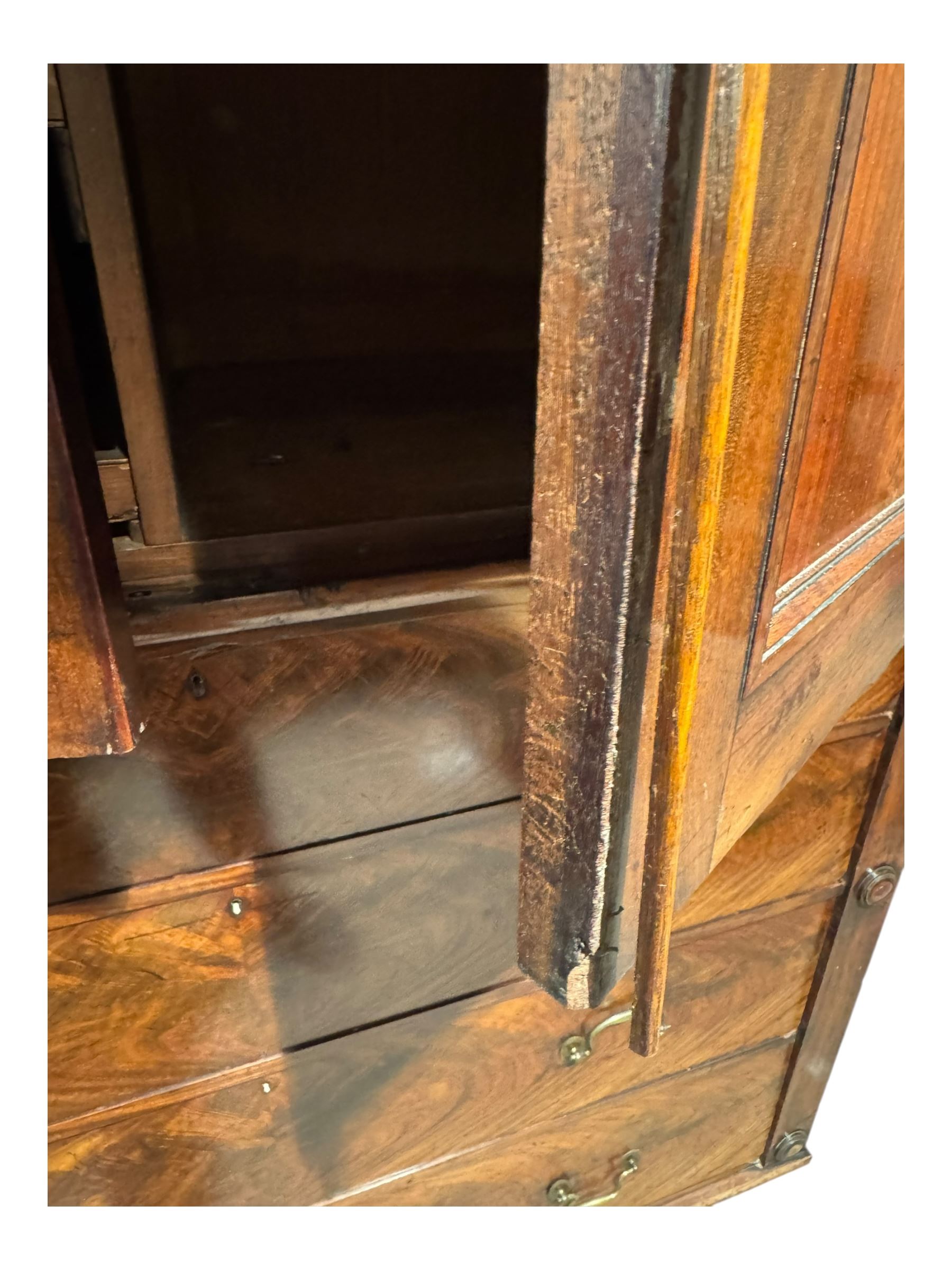 Victorian mahogany linen-press, moulded cornice over two figured panelled doors, the interior fitted with five slides and hanging rail, four long drawers below 