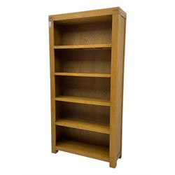 Light oak open bookcase fitted with four shelves 