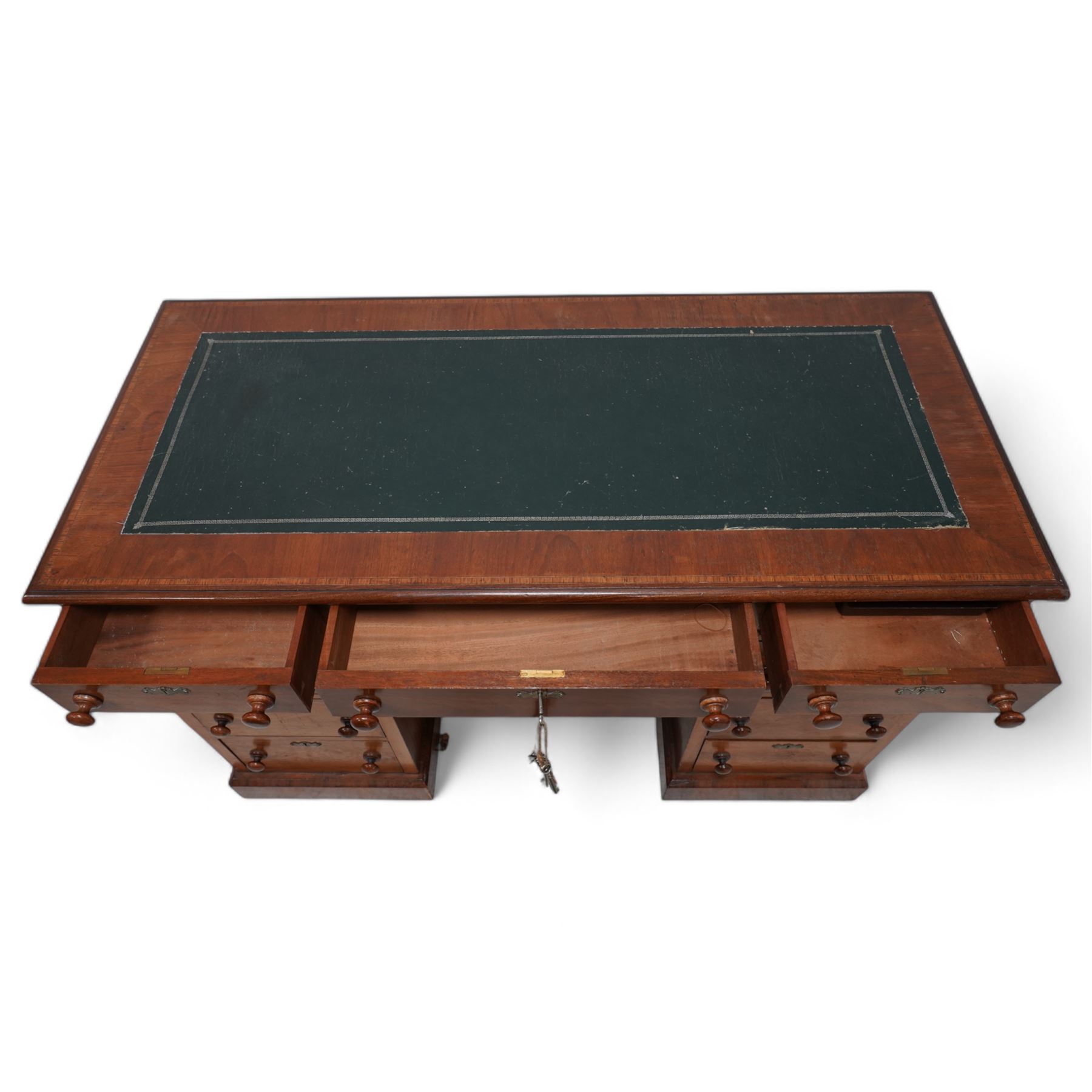 19th century mahogany twin pedestal desk, rectangular top with inset green leather writing surface, fitted with single frieze drawer flanked by four drawers to each side, each with shaped metal escutcheons, on skirted base