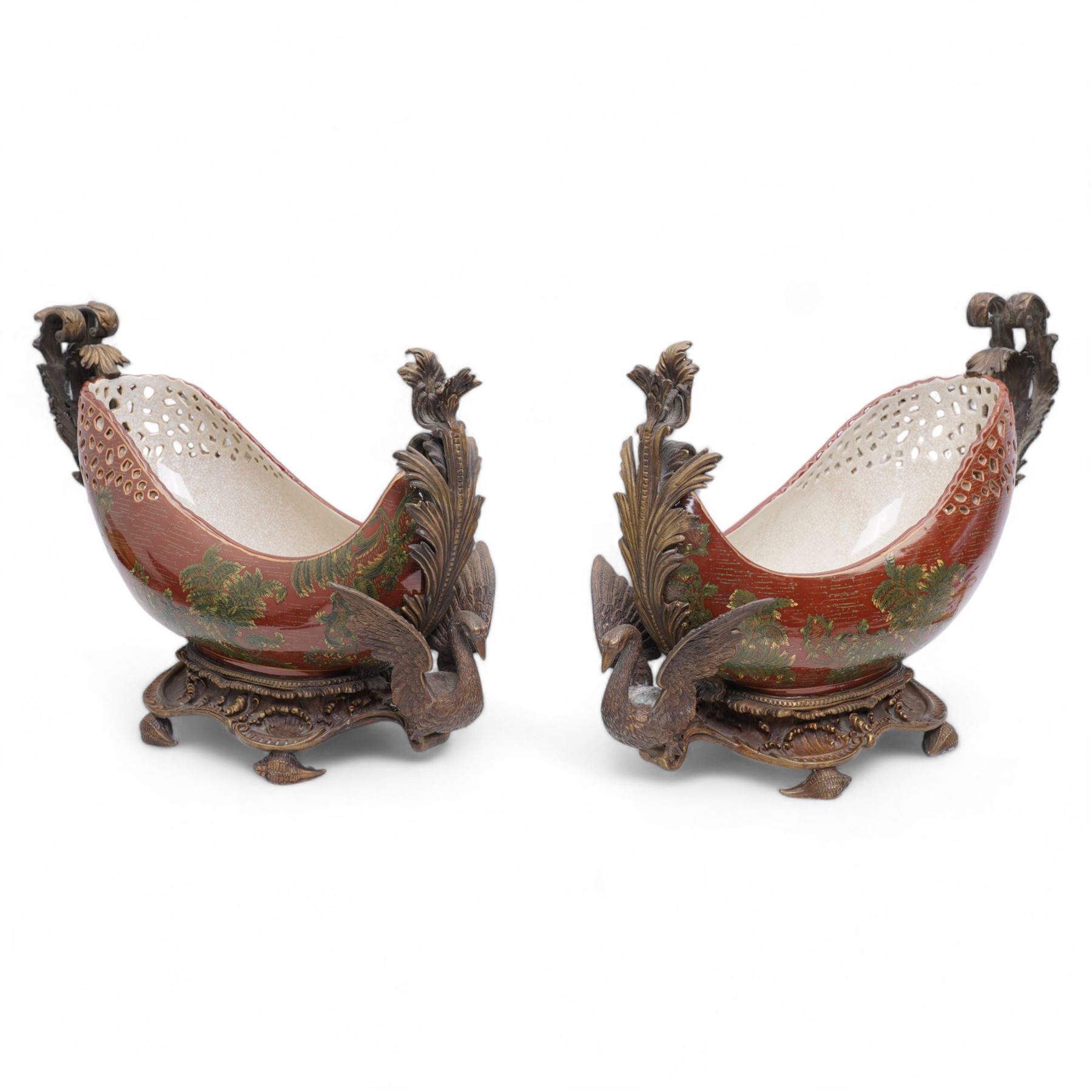 Pair of Continental ceramic and patinated metal table centre pieces, possibly by Castilian, each of boat form with pierced and polychrome decoration, with swan and shell moulded supports, H31cm x L46cm