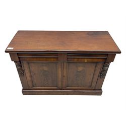 Mid 19th century mahogany sideboard, rectangular top over two frieze drawers with rounded edges, flanked by floral carved corbels, over two panelled cupboard doors, raised on a plinth base