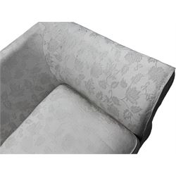 Two-seat traditionally shaped sofa, upholstered in pale floral pattern fabric, with additional covers