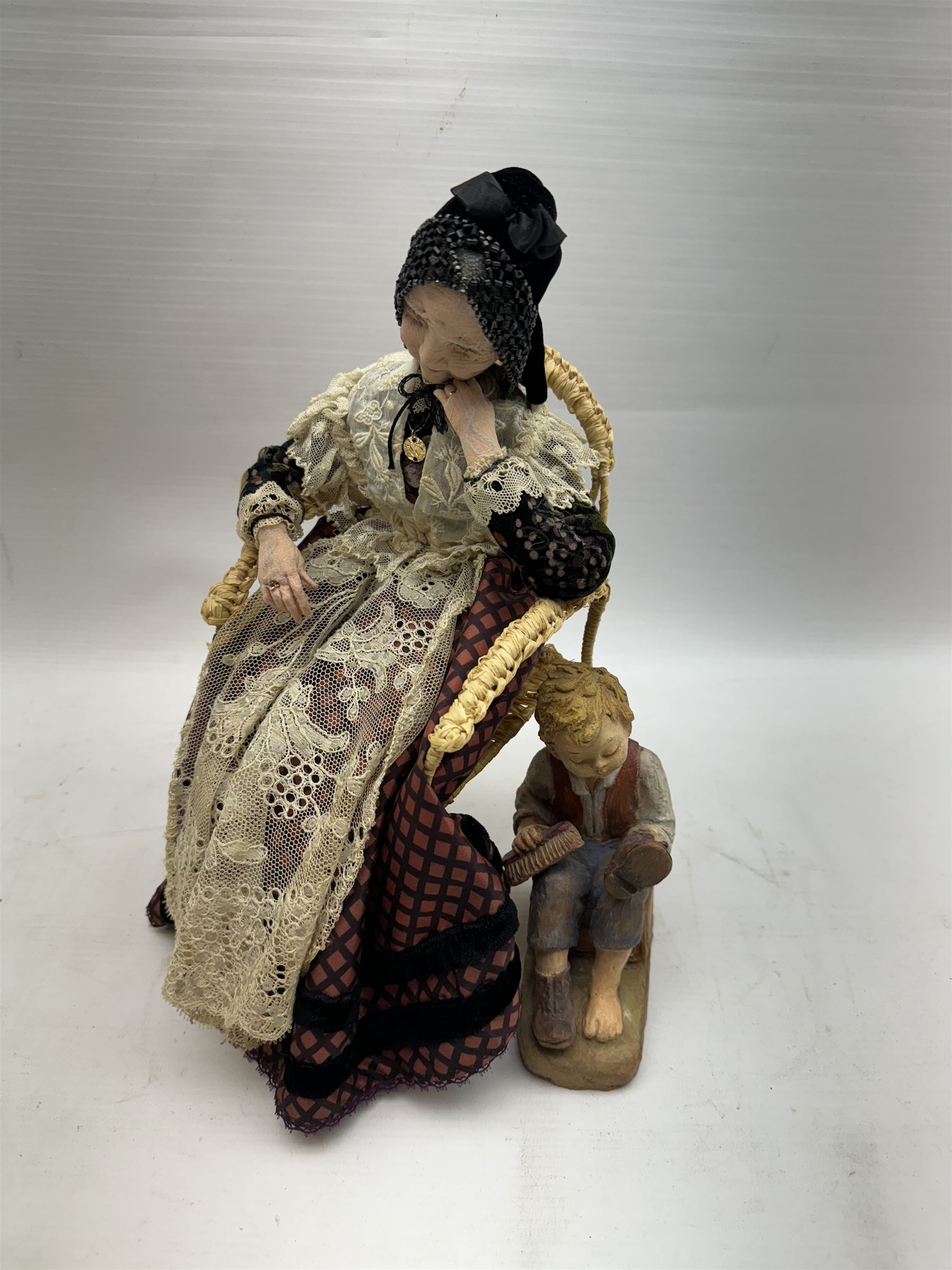 Anna Meszaros (Hungarian 1905-1998): 'My Great Granny', handmade needlework figurine, together with small plaster cast of a young boy by the same artist, granny H30cm
Auctioneer's Note: Anna Meszaros came to England from her native Hungary in 1959 to marry an English businessman she met while demonstrating her art at the 1958 Brussels Exhibition. Shortly before she left for England she was awarded the title of Folk Artist Master by the Hungarian Government. Anna was a gifted painter of mainly portraits and sculptress before starting to make her figurines which are completely hand made and unique, each with a character and expression of its own. The hands, feet and face are sculptured by layering the material and pulling the features into place with needle and thread. She died in Hull in 1998