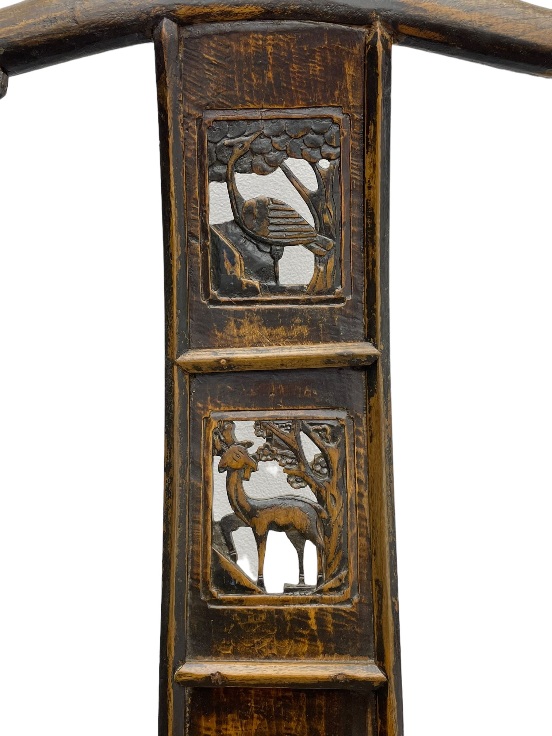 Chinese design elm yoke back 'official's' armchair, the shaped cresting rail over splat decorated with carved and pierced wildlife scenes, shaped projecting arms over rectangular seat, square supports united by plain stretchers, decorated with shaped frame brackets carved with foliage