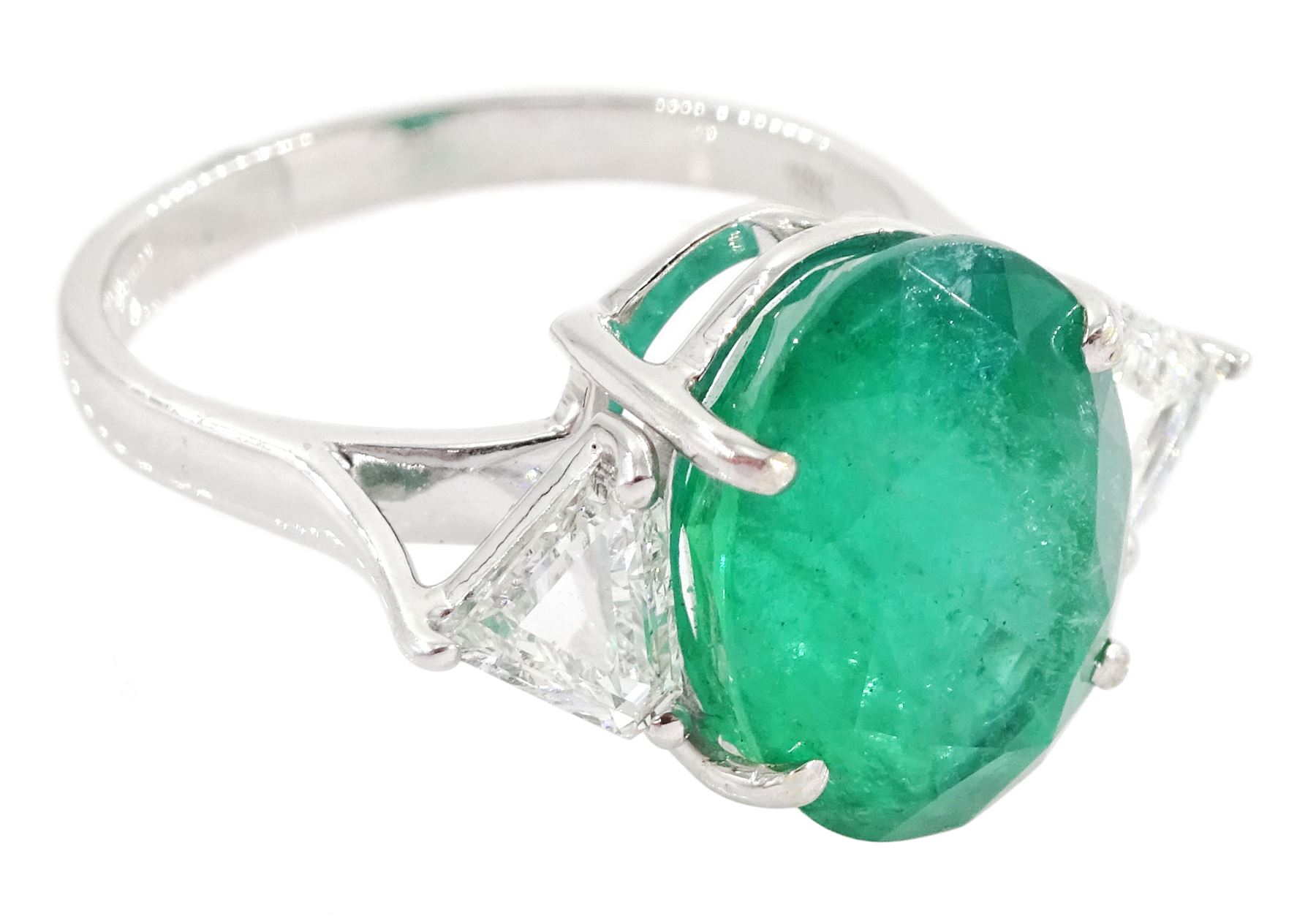 18ct white gold three stone oval cut emerald and trillion cut diamond ring, stamped, emerald approx 5.65 carat, total diamond weight approx 0.65 carat