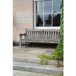 'J.V.T. Ampleforth' - teak garden bench, plain cresting rail with applied maker's plaque over slatted back and seat, on square supports 