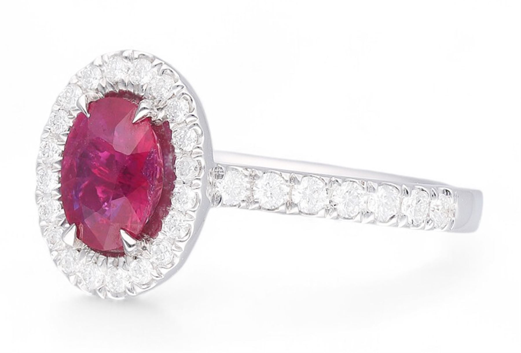 18ct white gold oval cut ruby and round brilliant cut diamond cluster ring, with diamond set shoulders, hallmarked, ruby approx 0.80 carat, total diamond weight 0.37 carat 