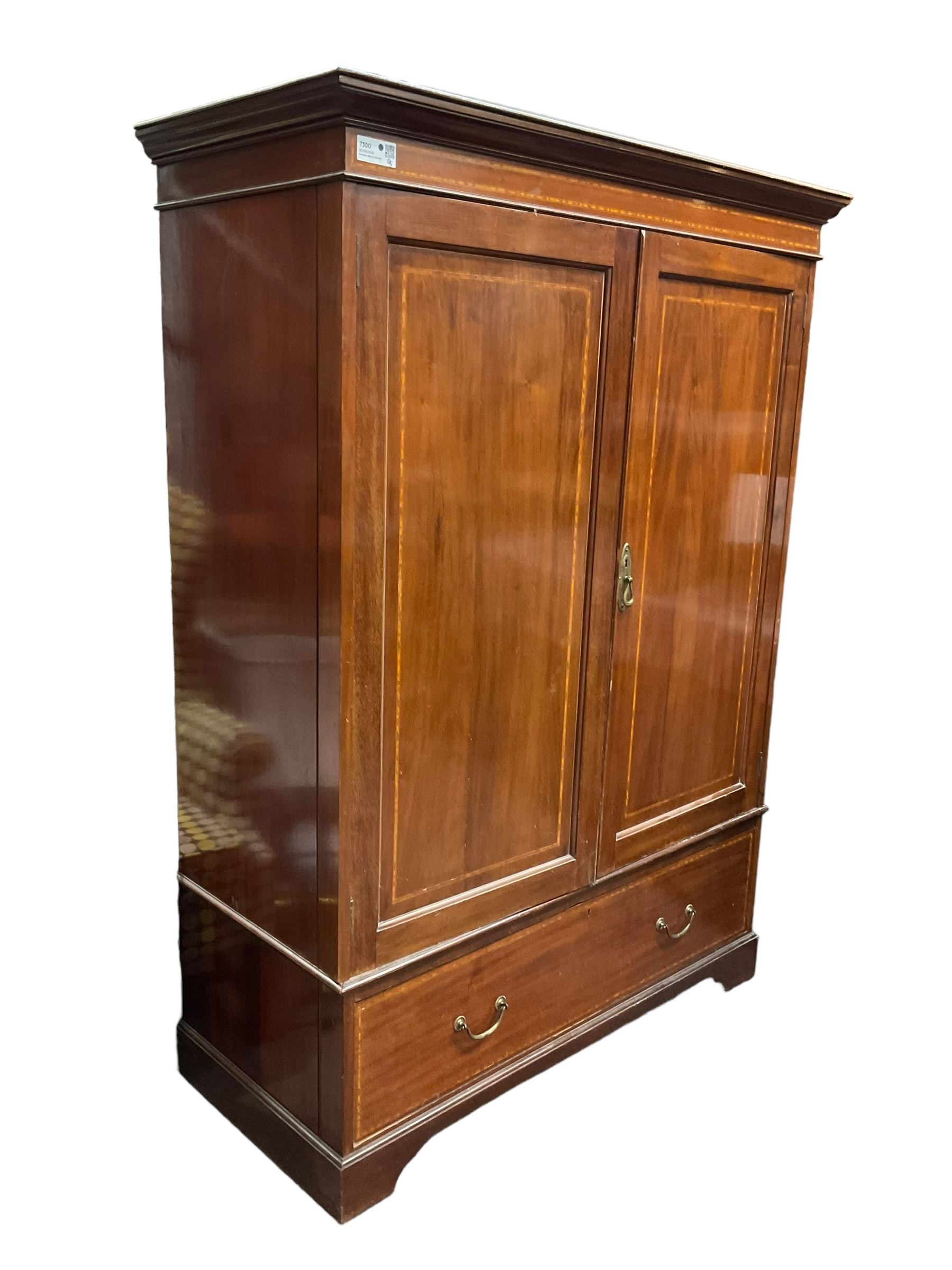 Edwardian inlaid mahogany double wardrobe, panelled doors enclosing sliding trays and hanging rail, fitted with single drawer to base