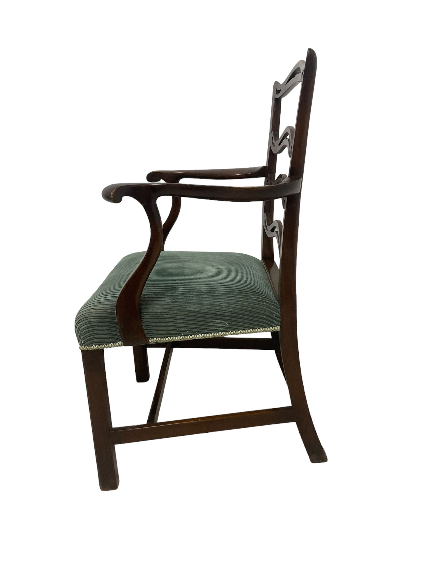 Set of twelve (10+2) Chippendale revival stained beech dining chairs, pierced waived ladder backs with over-stuffed over seats, on square moulded supports joined by stretchers