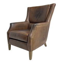 Club reading armchair, upholstered in brown Brazilian leather, studded detail, oak tapering legs