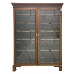 19th century mahogany bookcase, stepped moulded cornice over two astragal glazed doors, with five adjustable shelves, bone oval escutcheons, on bracket feet