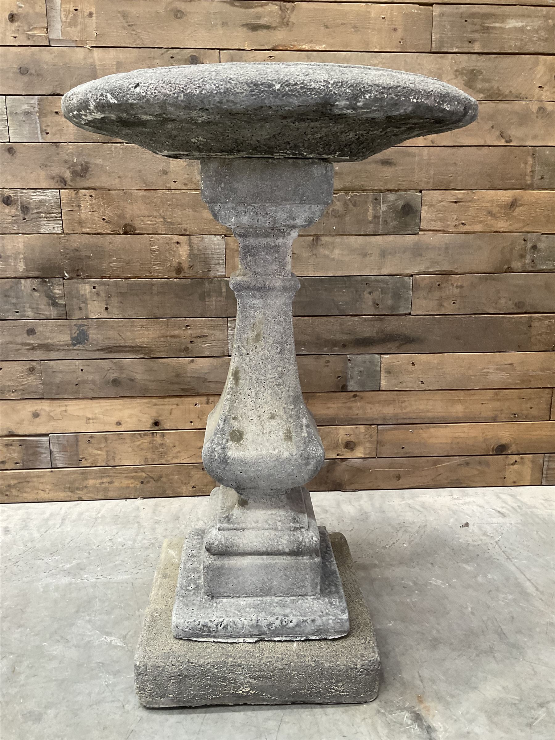 Cast stone garden bird bath, circular dished top, raised on square tapering column, on stepped base with separate mounting plinth