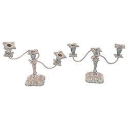 Walker and Hall turnover dish, engraved throughout with foliate decoration, with ivorine handle and upon four paw feet, together with a pair of silver plated candelabra and a pair of silver plated candlesticks, tallest H20cm