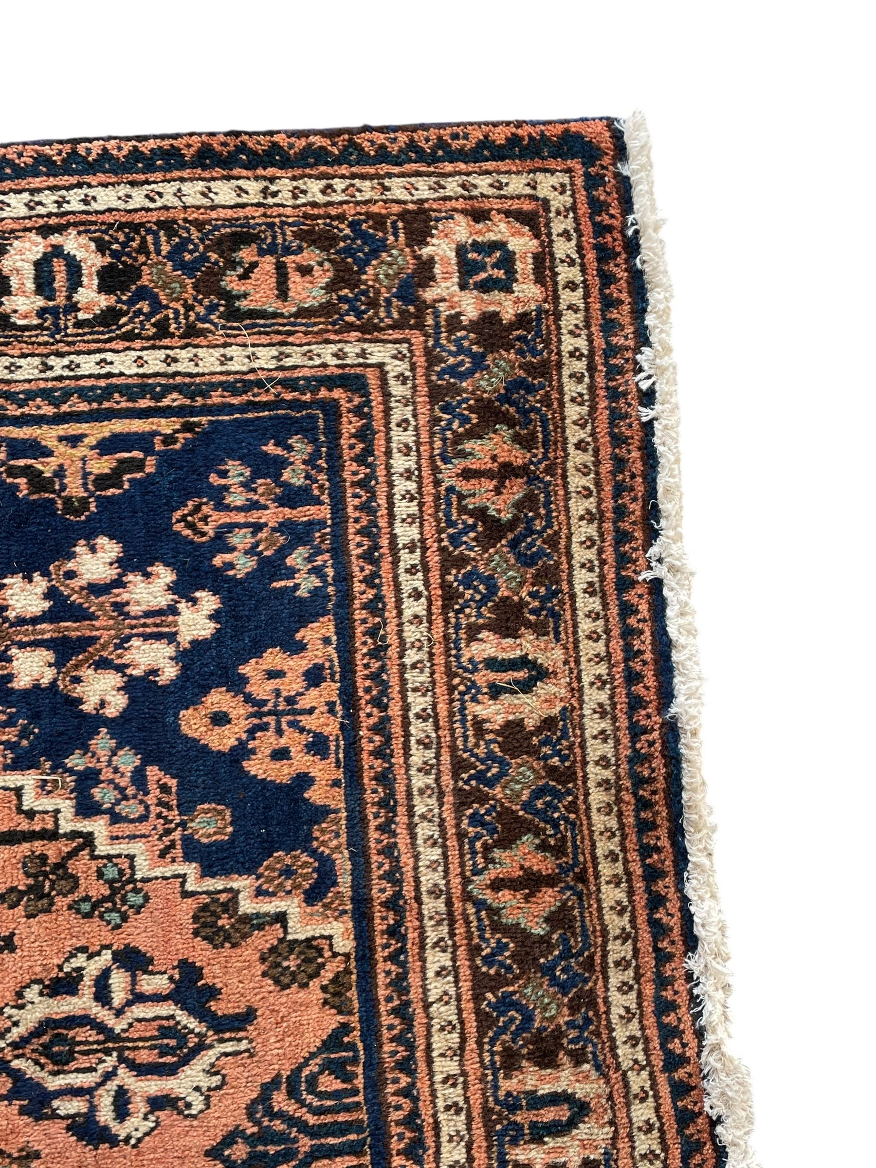 Persian Joshaghan peach and blue ground rug, central stepped lozenge medallion surrounded by bunches of floral motifs, repeating border decorated with stylised plant motifs, within multiple guard stripes