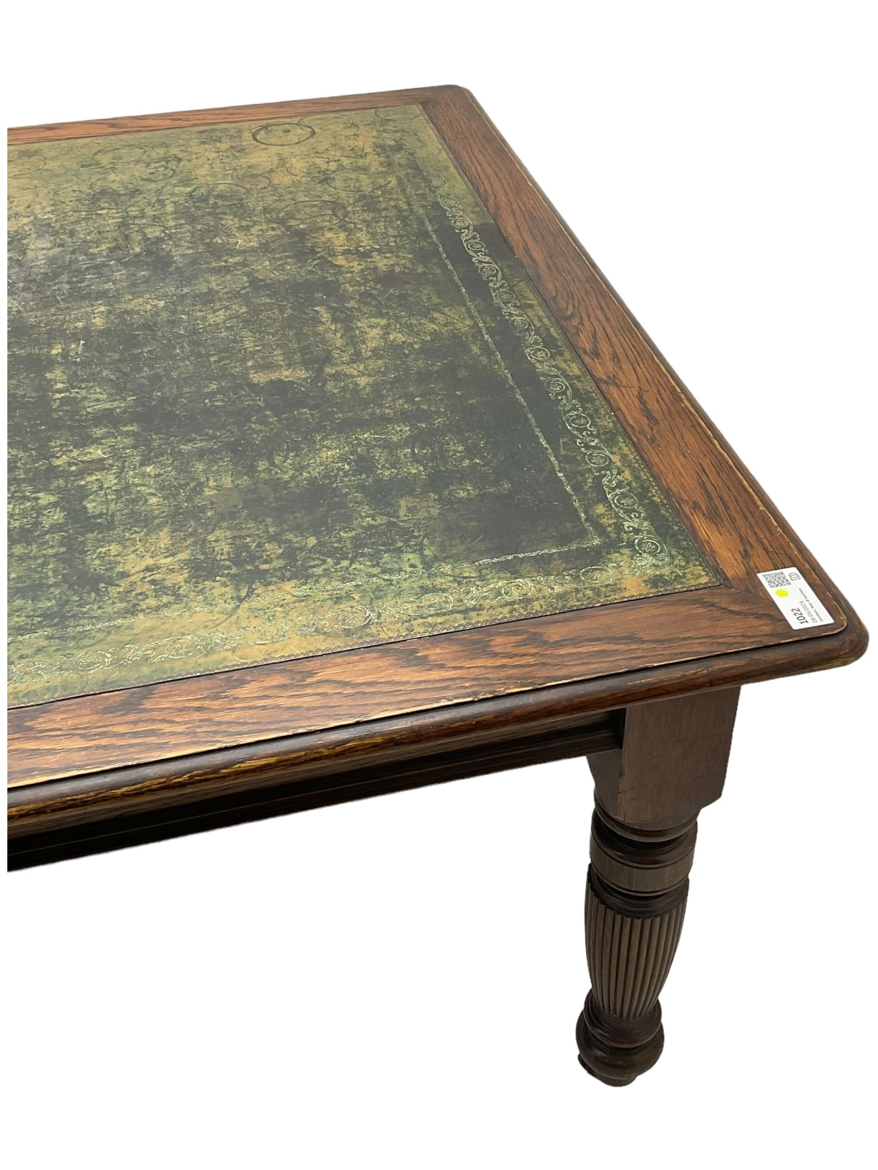 Large 10' 7'' late Victorian oak boardroom table, moulded rectangular top with inset green leather surface, on turned and reed moulded supports with brass and ceramic castors 