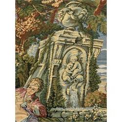 French machine woven tapestry, the scene depicting pastoral life with shepherds and sheep against a backdrop of lush foliage and classical architecture, bordered by a floral and scroll design