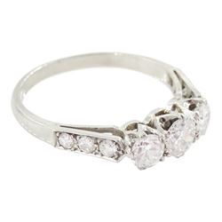 Early 20th century platinum three stone old cut diamond ring, with diamond set shoulders, total diamond weight approx 1.20 carat